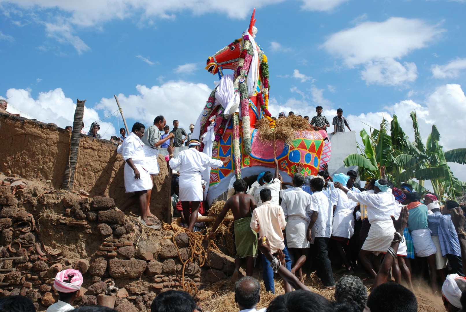 <span style="font-weight:normal;">The gigantic horse-offering for the Kuthadivayal festival being taken out of the oven in the potters' quarters in Aranthangi by more than one hundred devotees.</span>