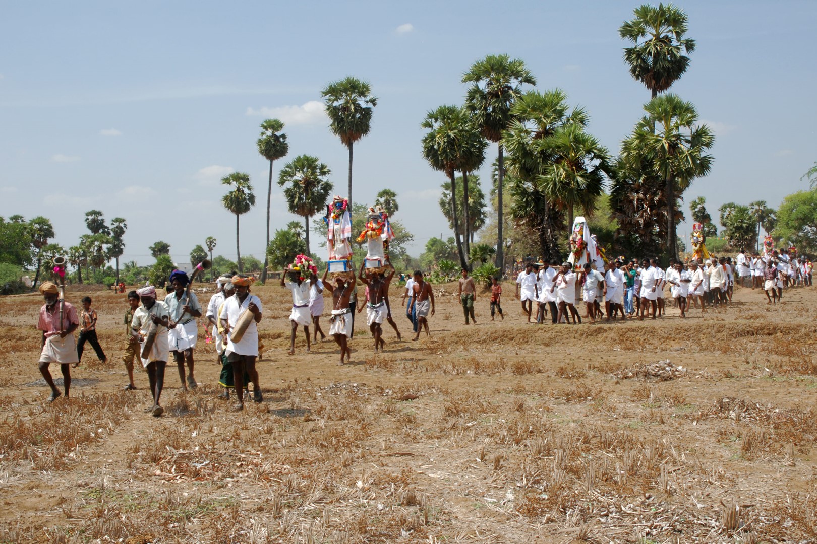 <span style="font-weight:normal;">Carrying offerings through the dried paddy-fields towards the shrine.</span>