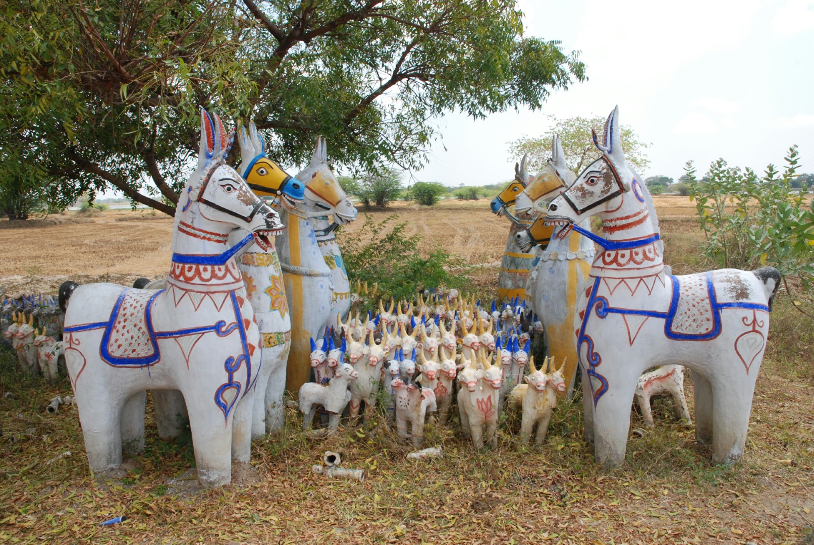 <span style="font-weight:normal;">In Karur, which is less a shrine than a group of statues in the middle of paddy fields and pasture, only two sorts of offerings are given at a small yearly festival: two life-sized horses and a few dozen double-headed cows. (This unusual creature represents the pair of bullocks needed to pull a bullock-cart, a ubiquitous vehicle in rural Tamil Nadu.)</span>