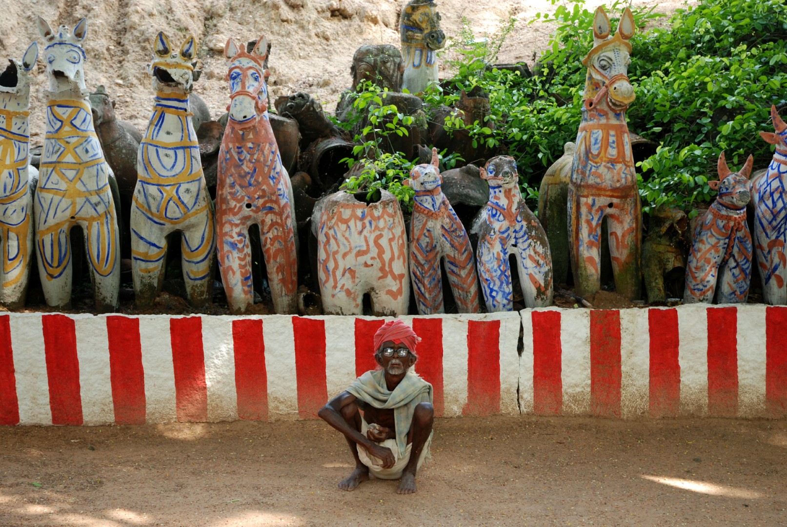 <span style="font-weight:normal;">A <i>kumbavishegam</i> (a ritual performed for the rejuvenation and regeneration of divine power) was performed at this shrine in Ilyangudipatti about four months before this photo was taken. For the ritual, the shrine’s walls were whitewashed and striped with red, and the central offerings – for the most part naked of their original water-based pigments and clothed in their original terracotta skin - were repainted with an unusual mixture of yellow, blue and orange!</span>