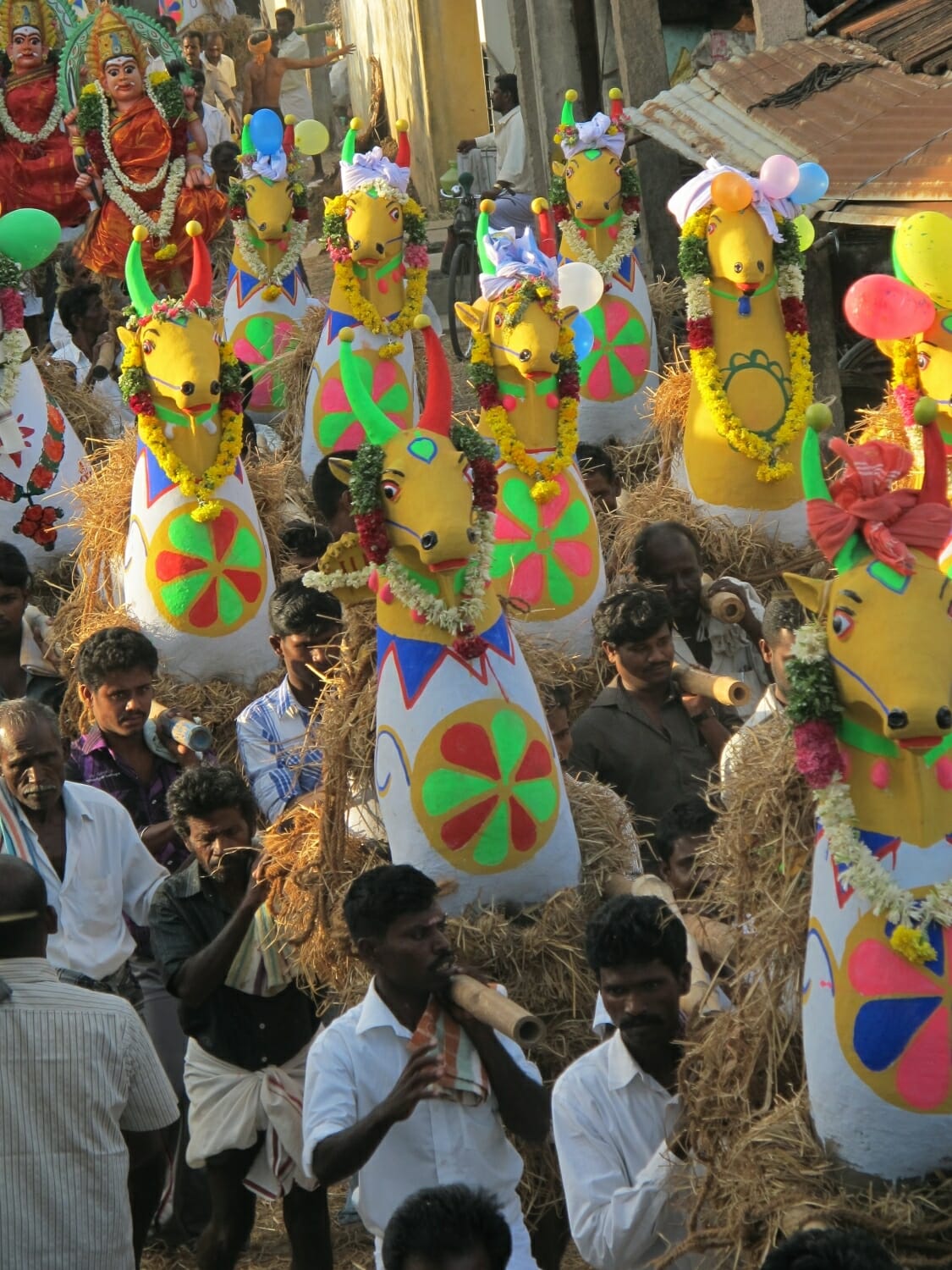 <span style="font-weight:normal;">Devotees leaving the potters' village carrying offerings on their shoulders.</span>