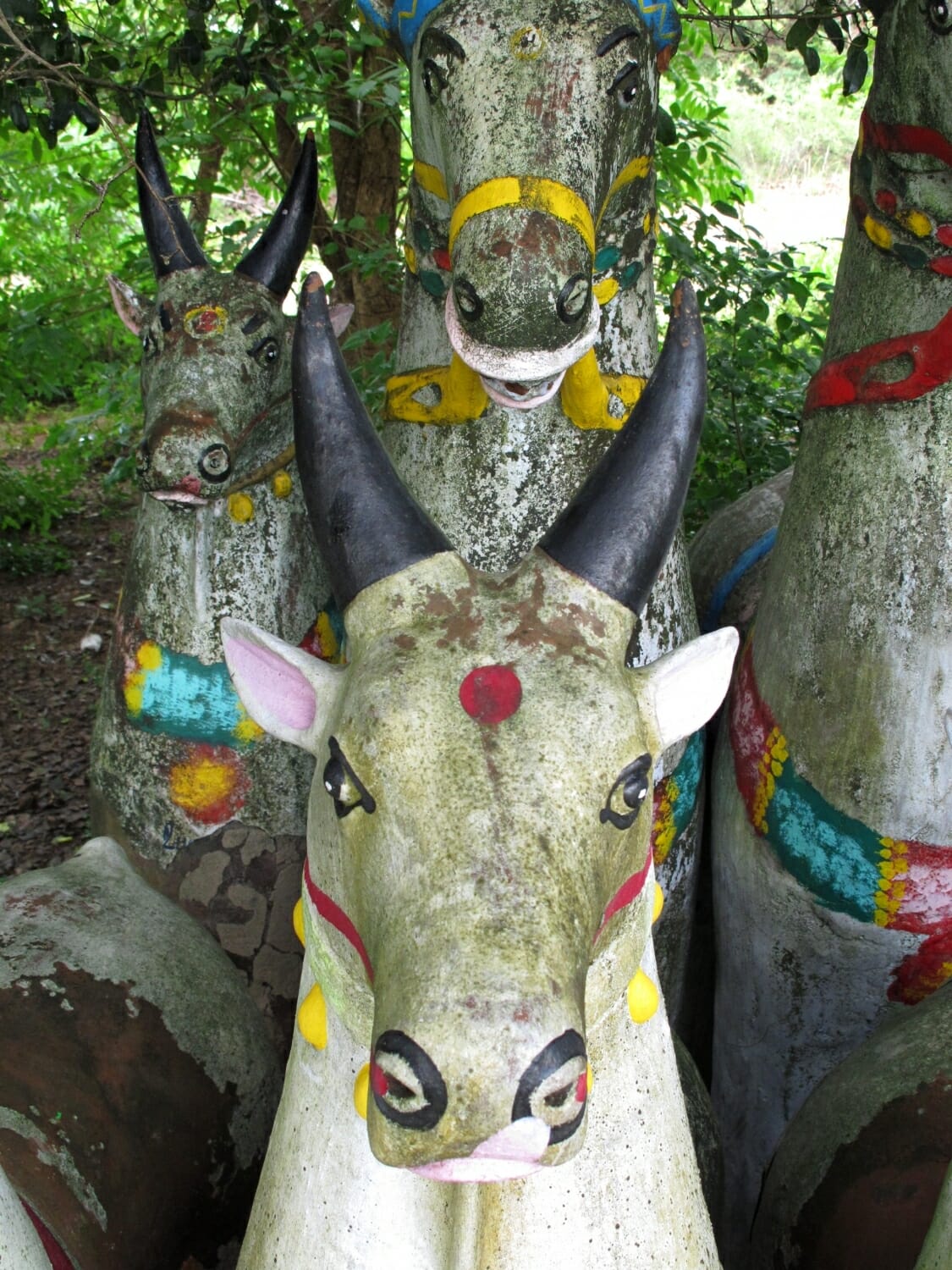 <span style="font-weight:normal;">In this shrine, the realism of form is enhanced by the choice of paint: all the animals - cows and horses alike - have been given white coats, pink ears and tongues, and black horns. The simplicity of colour and the patina of a few years of weathering have given this cow an appearence so lifelike that he's hypnotizing!</span>