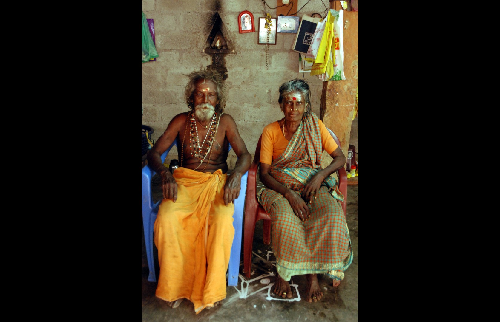 Mutthaiya and his wife in their courtyard